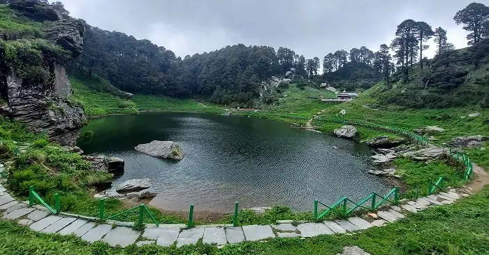 Serolsar Lake near Jalori Pass surrounded by lush forests in Himachal Pradesh