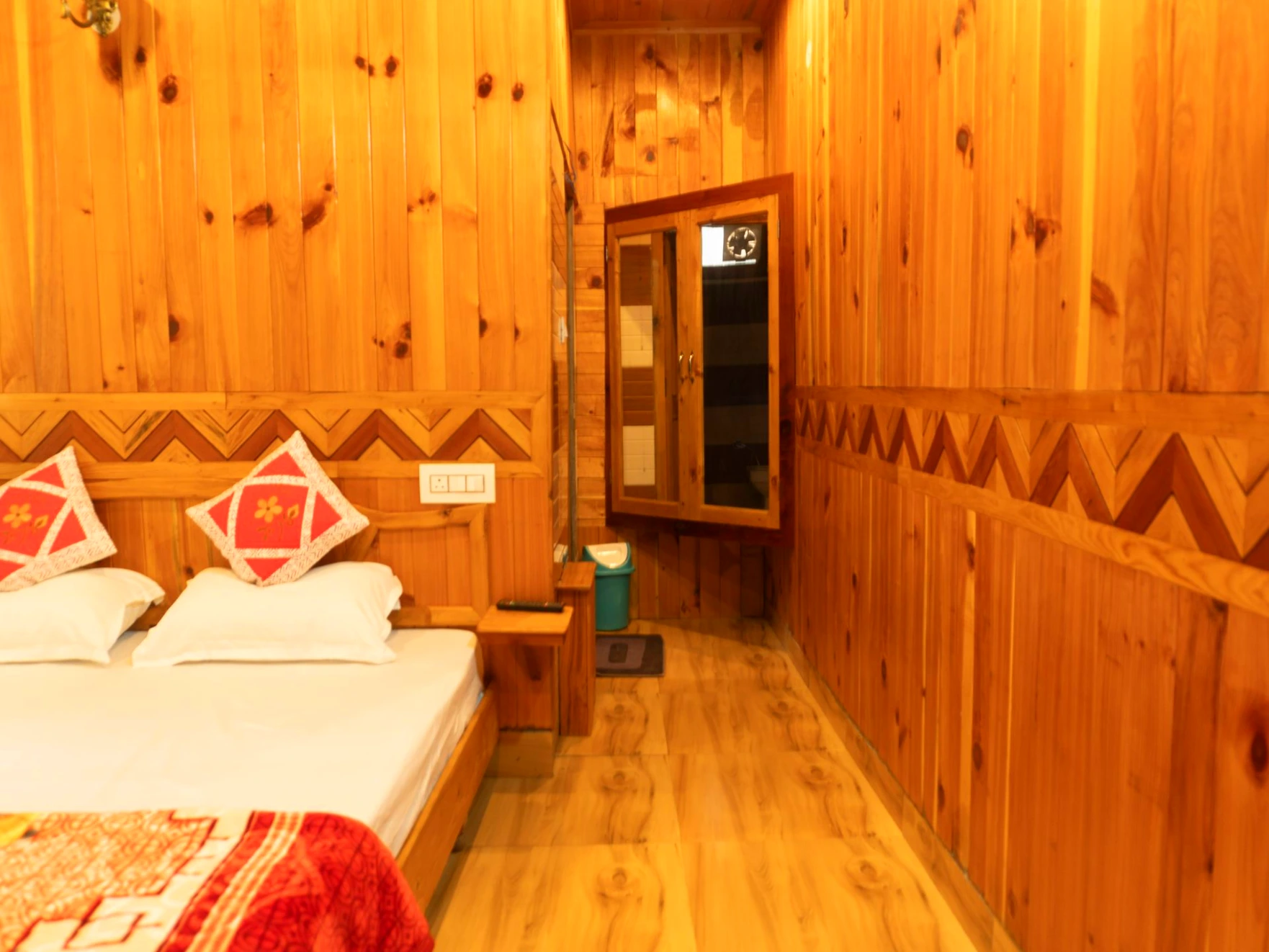 Comfortable bed with wooden interiors at The River Haven Homestay