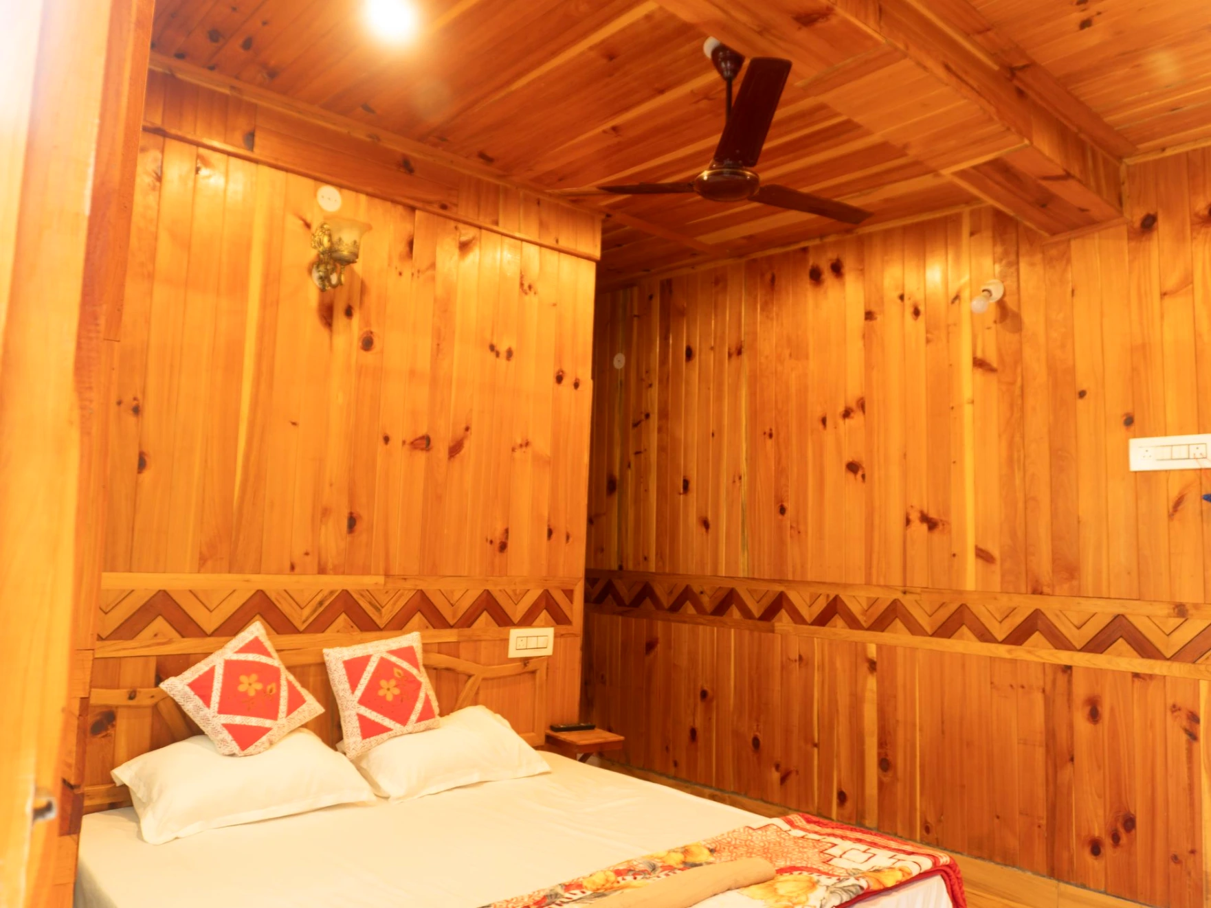 Comfortable bed with wooden interiors at The River Haven Homestay