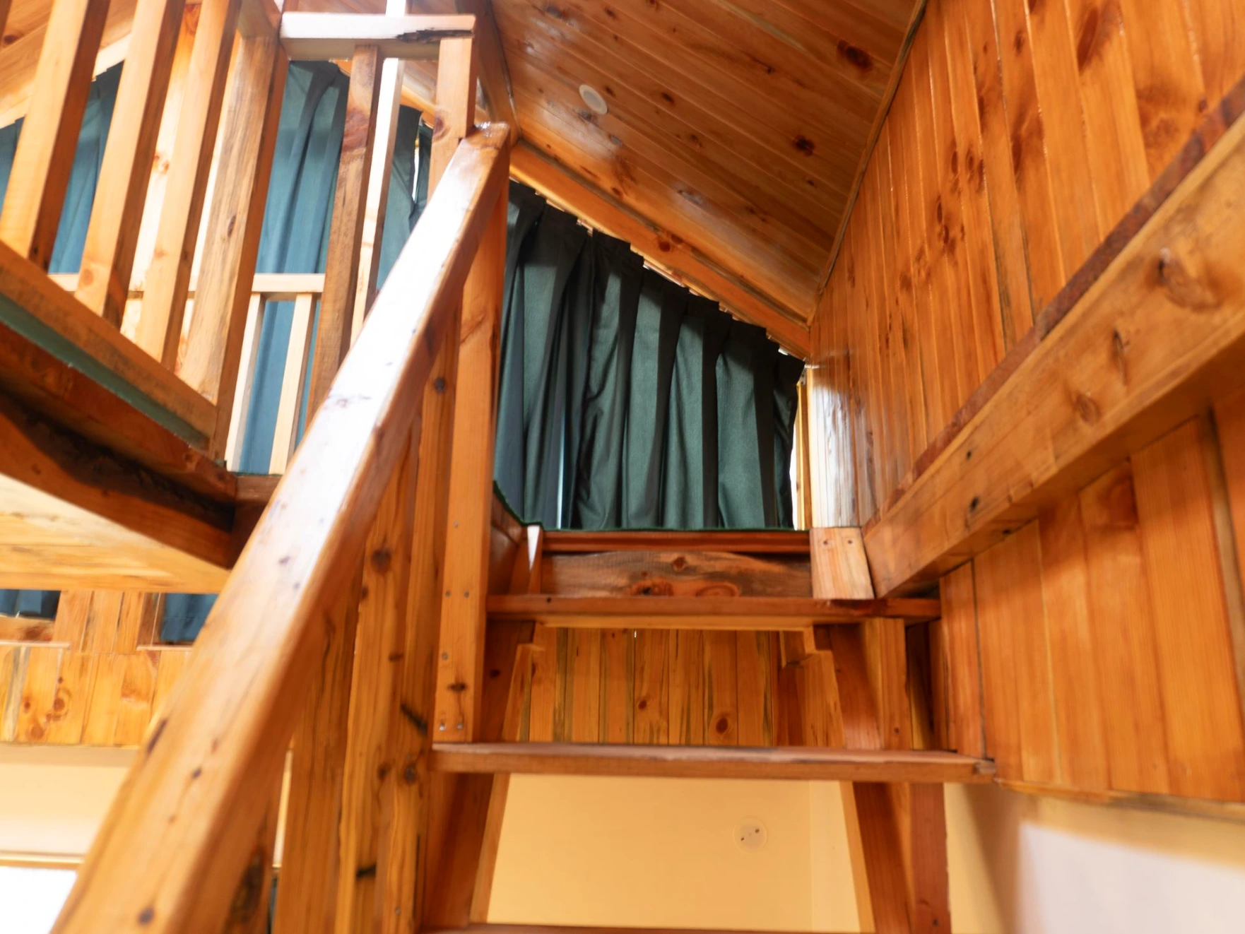 Duplex wooden room staircase at The River Haven Homestay in Tirthan Valley