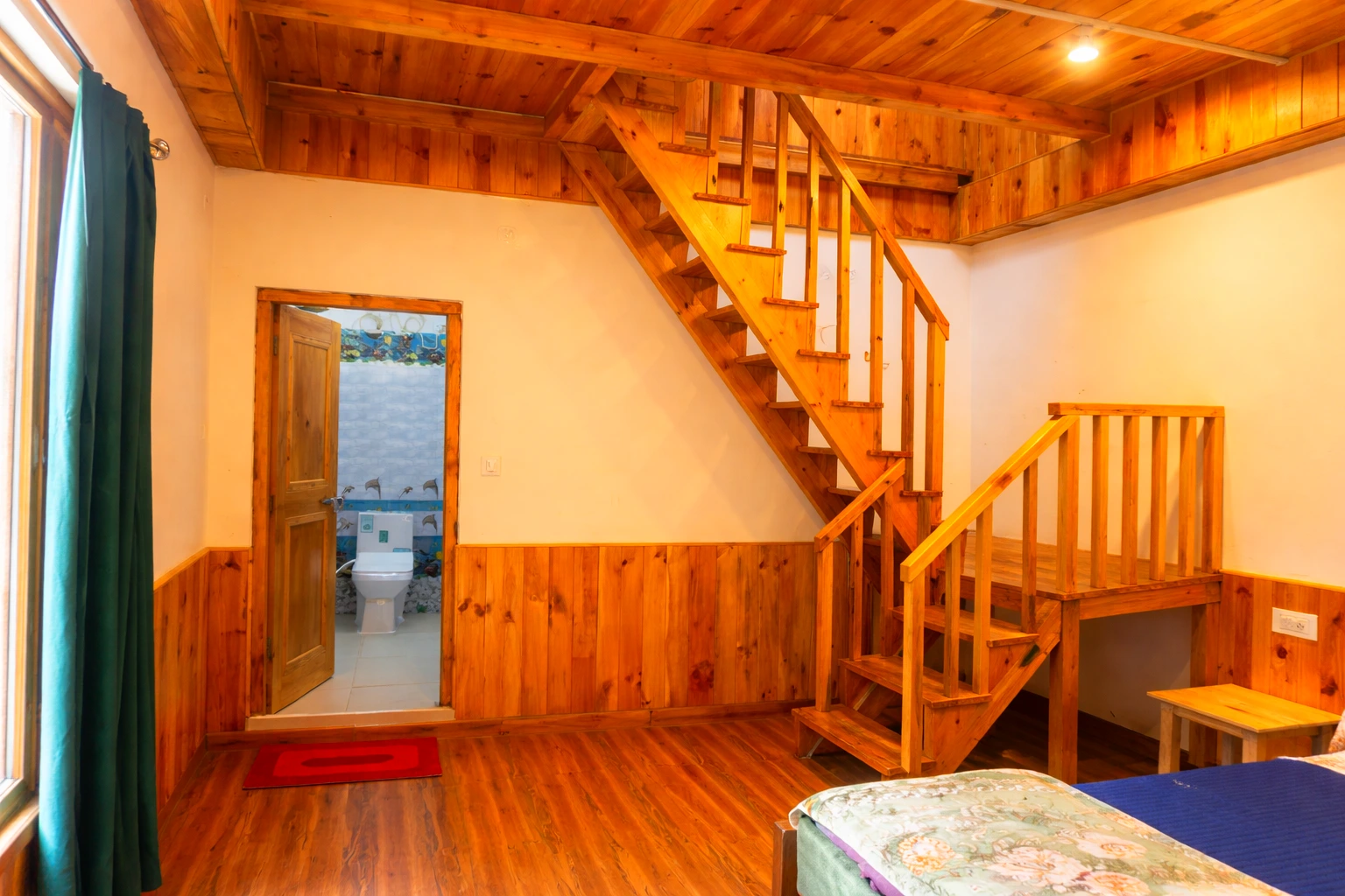 Duplex wooden room staircase at The River Haven Homestay in Tirthan Valley