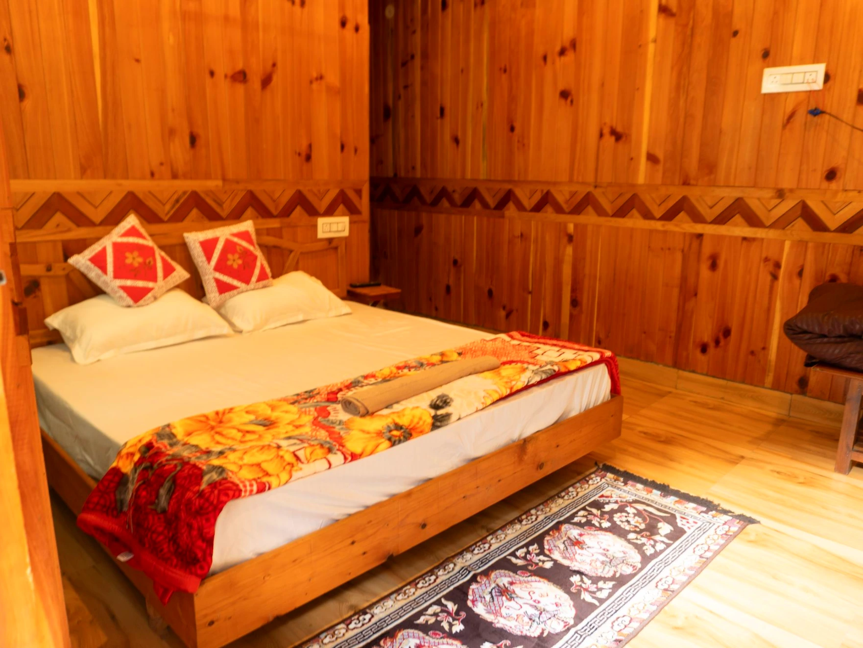 Comfortable bed with wooden interiors at The River Haven Homestay
