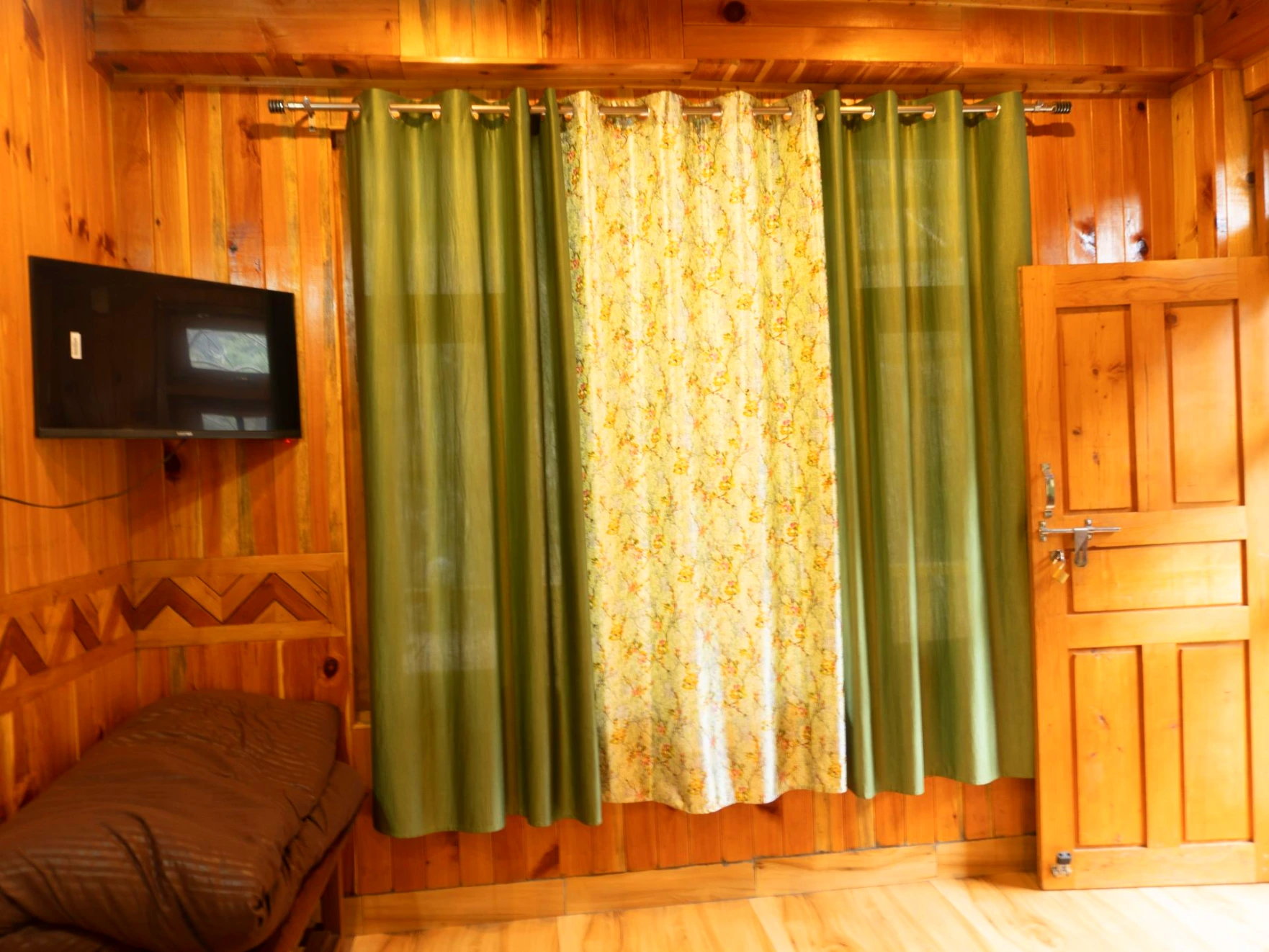 Comfortable bed with wooden interiors at The River Haven Homestay