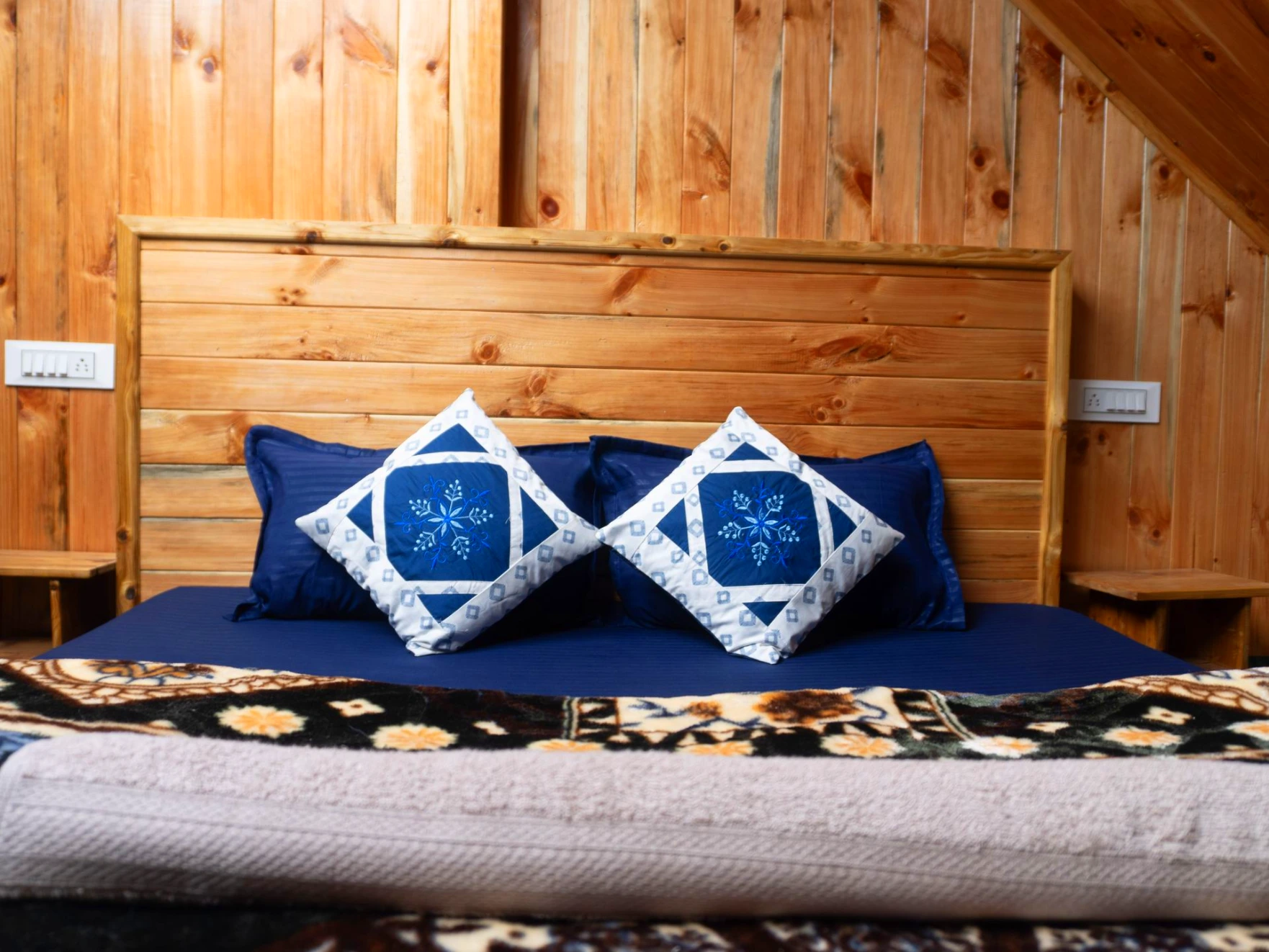 Comfortable bed with wooden interiors at The River Haven Homestay