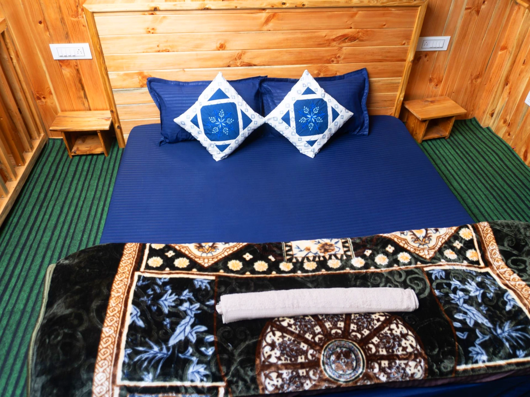 Comfortable bed with wooden interiors at The River Haven Homestay